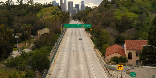 In this March 20, 2020 file photo, extremely light traffic moves along the 110 Harbor Freeway toward downtown mid-afternoon, in Los Angeles.