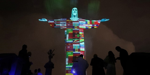 The statue of Christ the Redeemer is lit up in the colors of the countries that are affected by the coronavirus disease (COVID-19) outbreak in Rio de Janeiro, Brazil, March 18, 2020.