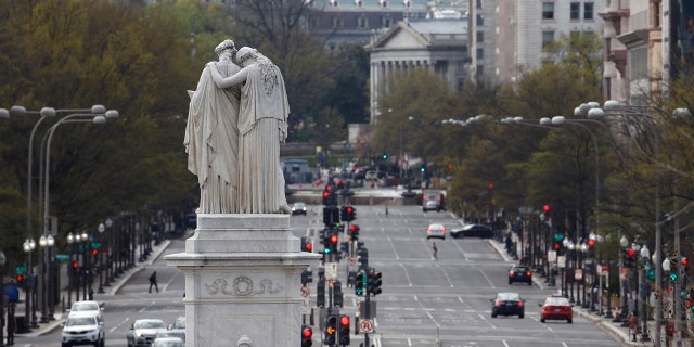 The Peace Monument faces a quiet Pennsylvania Avenue Northwest at rush hour, Monday, March 30, 2020, in Washington D.C.