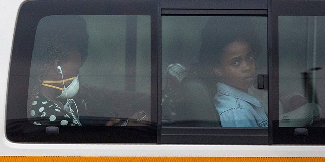 Passengers sit inside a minibus taxi on their way home to Kwa-Thema, a town east of Johannesburg, South Africa, on Tuesday. (AP Photo/Themba Hadebe)