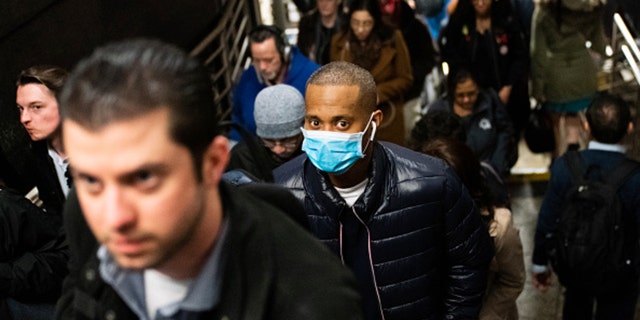 NEW YORK, NY - MARCH 09: A man wearing a protective mask is seen on a subway platform on March 9, 2020 in New York City. There are now 20 confirmed coronavirus cases in the city including a 7-year-old girl in the Bronx. (Photo by Jeenah Moon/Getty Images)