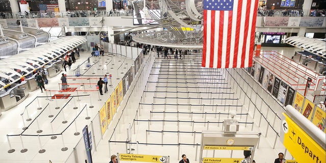 The area for TSA screening of travelers at JFK airport's Terminal 1 is relatively empty, Friday, March 13, 2020, in New York (AP Photo/Kathy Willens)