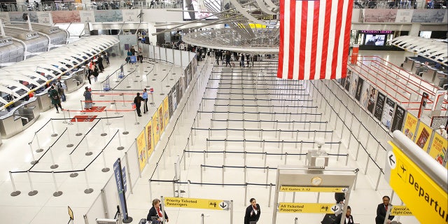 The area for TSA screening of travelers at JFK airport's Terminal 1 is relatively empty, Friday, March 13, 2020, in New York (AP Photo/Kathy Willens)