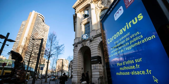 A general view of signs about coronavirus in the city of Mulhouse, eastern France, on Monday. (AP Photo/Jean-Francois Badias)