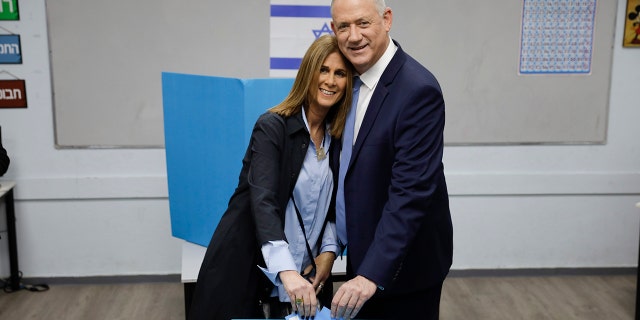 Gantz and his wife Revital vote in Rosh Haayin, Israel, on Monday in the country's third general election in less than a year. (AP Photo/Sebastian Scheiner)