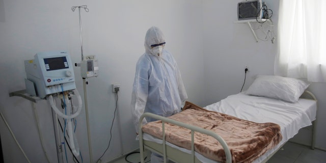 In this, Sunday, March 15, 2020 file photo, a medical staff member works on setting up an isolation room at a coronavirus quarantine ward at a hospital in Sanaa, Yemen.