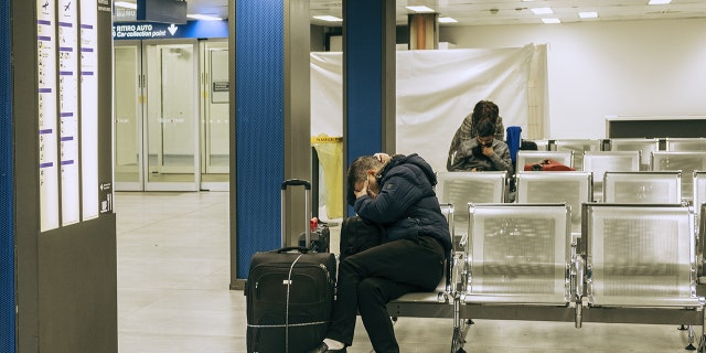 Passengers wait inside a terminal building at Linate airport in Milan, Italy, on Wednesday, Feb. 26. As the number of people infected by the coronavirus in Italy rises above 300 -- mostly in the rich, industrial north -- restrictions imposed to stem its spread are threatening deeper economic woes.
