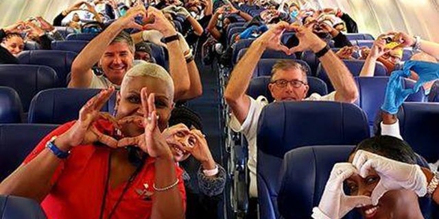 A spirited image of health care professionals, flight crew and passengers on a recent Southwest Airlines flight from Georgia, to help with the coronavirus outbreak in New York, has gone viral on social media.
