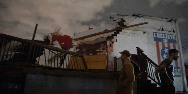 People stand outside the Basement East music venue in East Nashville after it was destroyed by a tornado on Tuesday, March 3, 2020.