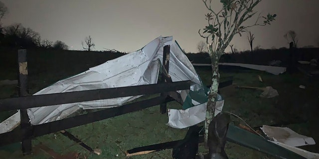 A damaged fence lies with debris at the Hidden Acres Farm after a tornado touched down in the area around Nashville, Tuesday, March 3, 2020.