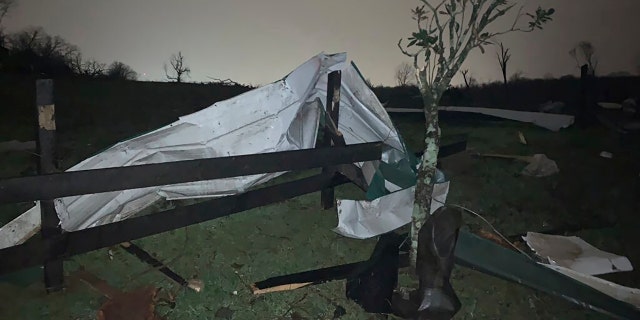 A damaged fence lies with debris at the Hidden Acres Farm after a tornado touched down in the area around Nashville, Tuesday, March 3, 2020.