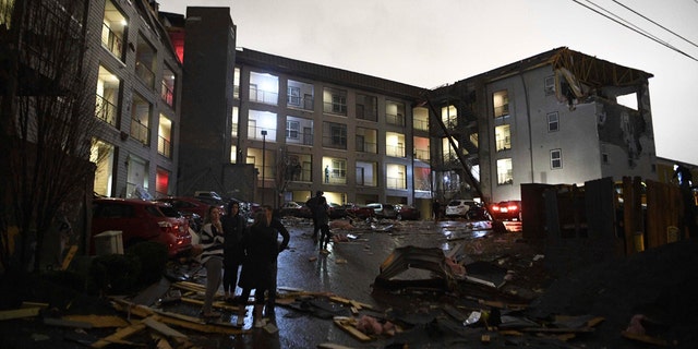 Debris is scattered across the parking lot of a damaged apartment building after a tornado hit Nashville in the early morning hours of Tuesday, March 3, 2020.
