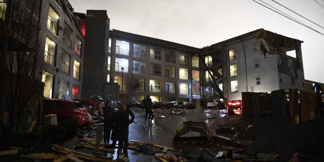 Debris is scattered across the parking lot of a damaged apartment building after a tornado hit Nashville in the early morning hours of Tuesday, March 3, 2020.