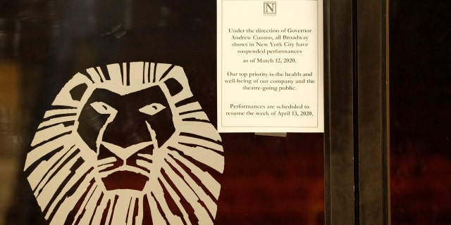 A sign announcing the suspension of all Broadway shows is posted on a door at the Minskoff Theatre, where "The Lion King" had been playing, Thursday, March 12, 2020, in New York. Gov. Andrew Cuomo banned gatherings of more than 500 people. (AP Photo/Kathy Willens)