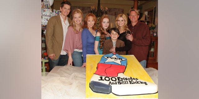 Steve Howey, Melissa Peterman, Reba McEntire, Joanna Garcia, Mitch Holeman, Scarlett Pomers and Christopher Rich from the cast of "Reba" attend a celebration of the show's 100th episode December 12, 2005 in Culver City, California.