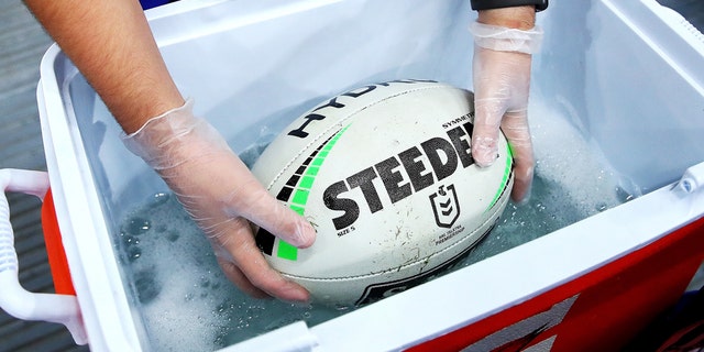 A ballboy washes the ball during the round 2 NRL match between the Canterbury Bulldogs and the North Queensland Cowboys at ANZ Stadium on March 19, 2020 in Sydney, Australia. Due to the COVID-19 virus outbreak, the fixture is the first top-level Sydney rugby league match played in 112 years where fans are locked out of the ground. This is due to a NSW Public Health Order prohibiting outdoor events with more than 500 people. (Photo by Cameron Spencer/Getty Images)