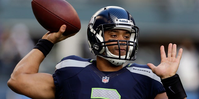 Seattle Seahawks quarterback Russell Wilson passes during warm-ups before an NFL football game against the St. Louis Rams, Sunday, Dec. 30, 2012, in Seattle. (AP Photo/Elaine Thompson)