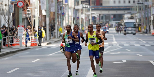 Ethiopia's Birhanu Legese, right in second row, races with other runners on his way to winning the Tokyo Marathon in Tokyo.
