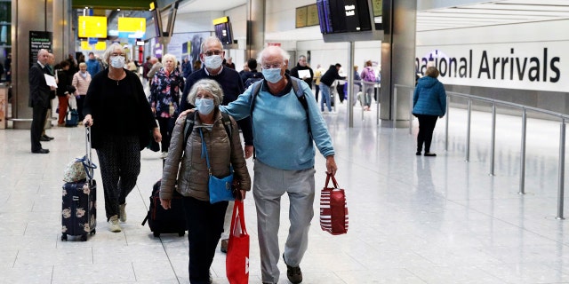 Passengers from the coronavirus hit Braemar cruise ship return to Heathrow Airport in London, on Thursday, March 19, 2020.