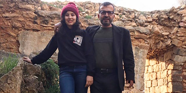 Ismail Mousa and his daughter Anisa of Selbyville, Del., pose for a photograph on March 12 while sightseeing near the Palestinian village of Qaryout in the West Bank. (Reem Mousa via AP)
