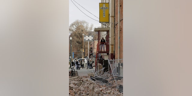 A man looks at the rubble after an earthquake Wednesday, March 18, 2020, in Salt Lake City.