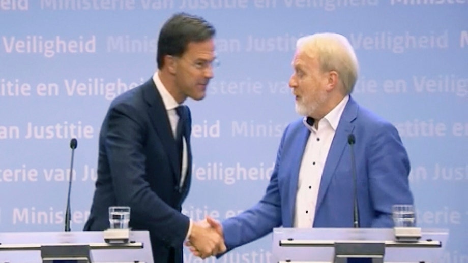 Dutch prime minister warns public against shaking hands – promptly does it moments later