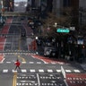 A person walks across an almost empty 42nd Street as people were told to stay home to prevent the spread of the coronavirus in New York City, March 22, 2020. 