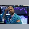 Meric Greenbaum a trader with Designated Market Maker IMC Financial looks up at the board before the opening bell before trading was halted on the New York Stock Exchange in New York City, March 9, 2020.