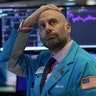 Meric Greenbaum a trader with Designated Market Maker IMC Financial looks up at the board before the opening bell before trading was halted on the New York Stock Exchange in New York City, March 9, 2020.