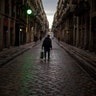 A man walks along an empty street as the lockdown to combat the spread of coronavirus continues in Barcelona, Spain, March 26, 2020. 