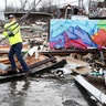 A man makes his way through debris following a deadly tornado in Nashville on Tuesday, March 3, 2020.