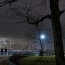 People walk along the Hudson River as fog shrouds lower Manhattan in New York City, March 4, 2020.