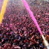 Indian Hindu devotees cheer as colored powder and water is sprayed on them by a Hindu priest during celebrations marking Holi at the Swaminarayan temple in Ahmedabad, India, March 10, 2020.