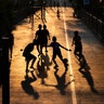 Children play soccer in the afternoon light in Bangkok, Thailand, March 25, 2020. 
