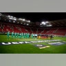 The teams of Wolverhampton Wanderers, left, and Olympiakos standing on the pitch prior the Europa League round of 16 first leg soccer match at the Karaiskakis Stadium in Piraeus, Greece, Mar. 12, 2020.