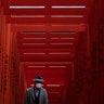 A man with a mask walks through Torii Gates at the Hie Shrine in Tokyo, Japan, March 1, 2020. 