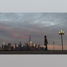 A woman stands in front of the skyline of lower Manhattin on Pier A in Hoboken, N.J., March 17, 2020.