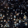 Crowds wearing protective masks, following an outbreak of the coronavirus, are seen at the Shinagawa train station in Tokyo, Japan, March 2, 2020. 