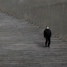 A man wearing a face mask walks down the stairs at Dongdaemun Design Plaza in Seoul, South Korea, March 19, 2020. 