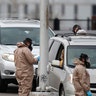 Colorado National Guard medical personnel perform coronavirus tests on motorists at a drive-through testing site outside the Denver Coliseum in Denver, Colo., March 14, 2020.