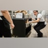 Ileana Koons organizes vegetable and meat options as the kitchen preps meals to get picked up and delivered to students in Bothell, Wash, March 12, 2020.