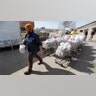 Patrick Minor loads food onto a delivery truck at the Des Moines Area Religious Council food pantry in Des Moines, Iowa, March 17, 2020.