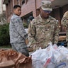 Members of the New York National Guard helping to organize and distribute food to families on free or reduced school lunch programs in New Rochelle, N.Y., Thursday, March 12, 2020. 