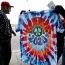 Jay Forbes selling shirts outside the Huntington Convention Center of Cleveland as a customer held up a Bernie 2020 shirt.