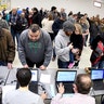 Caucus voters standing in line to register before voting at the North Dakota Democratic NPL Presidential Caucus inside the AFL-CIO House of Labor in Bismarck, N.D.