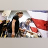 Voting machine operator David Schaefer, right, helps voter Kaitron Gordon with her ballot on Tennessee's Super Tuesday primary election at the Cleveland Park Community Center precinct. Super Tuesday polls stayed open late in Nashville after deadly overnight tornadoes delayed the start of voting in the city and rendered some of its polling places unusable.