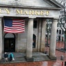 A couple walks onto a deserted plaza at the usually busy tourist site at Quincy Market in Boston, Friday, March, 13, 2020.
