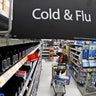  A woman looks at the few selections remaining in the cold and flu aisle of a Walmart near Warrendale, Pa. Walmart, the nation’s largest retailer and private employer, said late Saturday, March 14, 2020, it is limiting store hours to ensure they can keep sought-after items such as hand sanitizer in stock amid the coronavirus pandemic. 