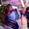 A customer wears a mask while visiting a market, in Pamplona, northern Spain, on March 13, 2020.