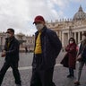 Tourists wearing masks walk in St. Peter's Square at the Vatican, on March 6, 2020. That day, a Vatican spokesman confirmed the first case of coronavirus at the city-state. 